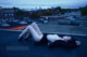 A woman laying on top of a roof with her legs crossed.