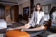 A woman sitting on top of a table in a hotel room.