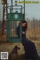 A woman sitting on a bench next to a dog.