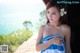 A woman in a blue and white towel with a flower in her hair.