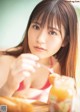 A woman sitting at a table with a glass of orange juice.