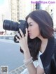 A woman taking a picture of herself with a camera.