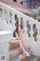 A woman sitting on the steps of a building.