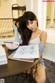 A woman sitting at a table with a bowl of food.