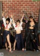 A group of young women dressed in costumes posing for a picture.